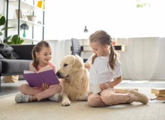 From Summer Snuggles to School Schedules Two children reading with a Golden Retriever at home